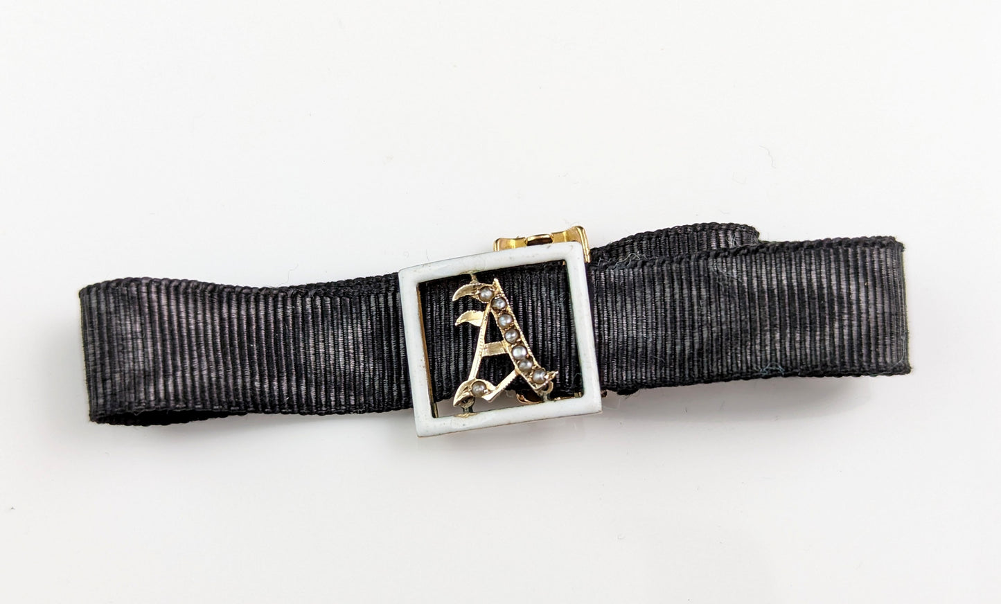 Antique A initial slider bracelet, White enamel and pearl, 9ct gold, black silk